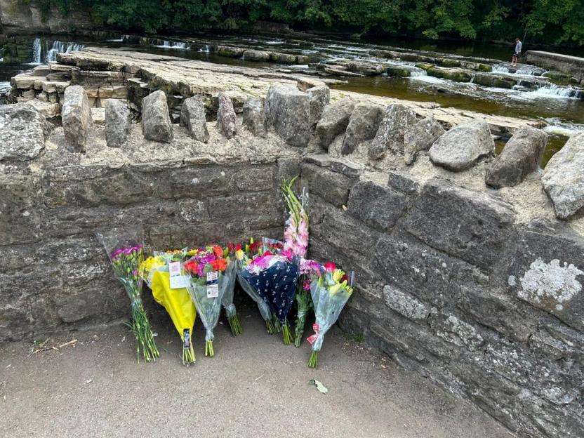 Floral tributes left at Richmond Falls on the River Swale.