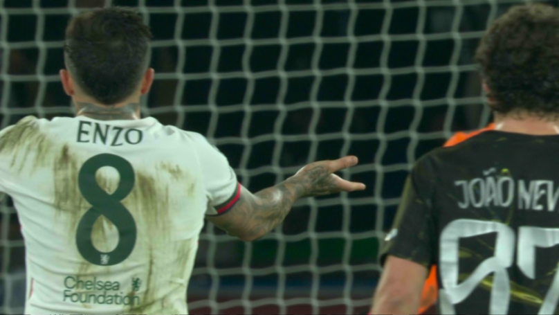 Football player Enzo pointing while facing the goal.