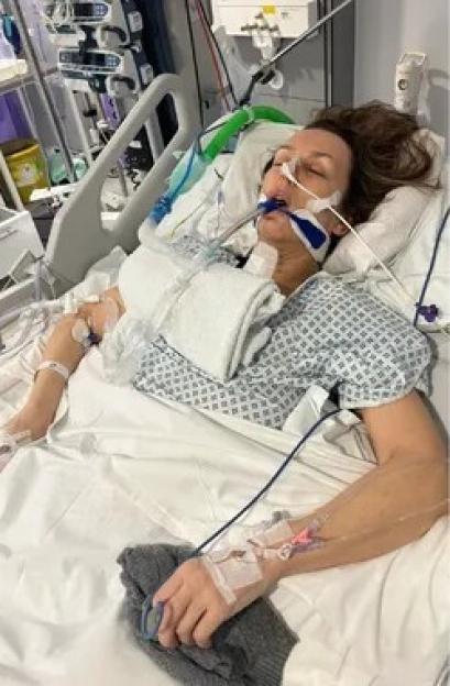 Trudi Burgess in a hospital bed with medical tubes and devices, after her neck was snapped by her former partner.