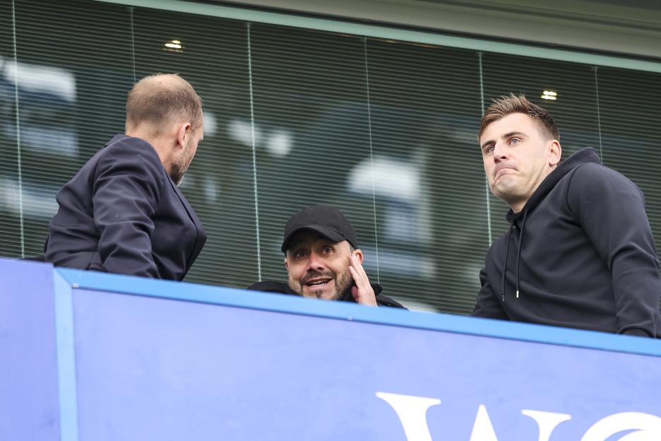 Chelsea Sporting Director Paul Winstanley and Head Coach Roberto De Zerbi watching a soccer match.
