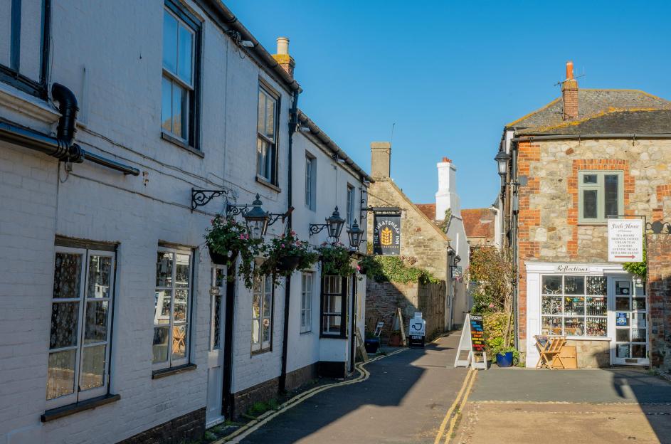 The historic streets of Yarmouth, Isle of Wight, showing "The Wheatsheaf Inn" and shops.