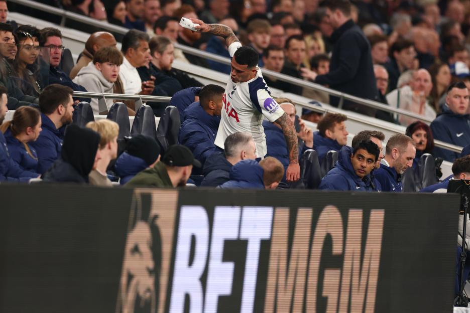 Pedro Porro throws a water bottle after being substituted during a Premier League match.