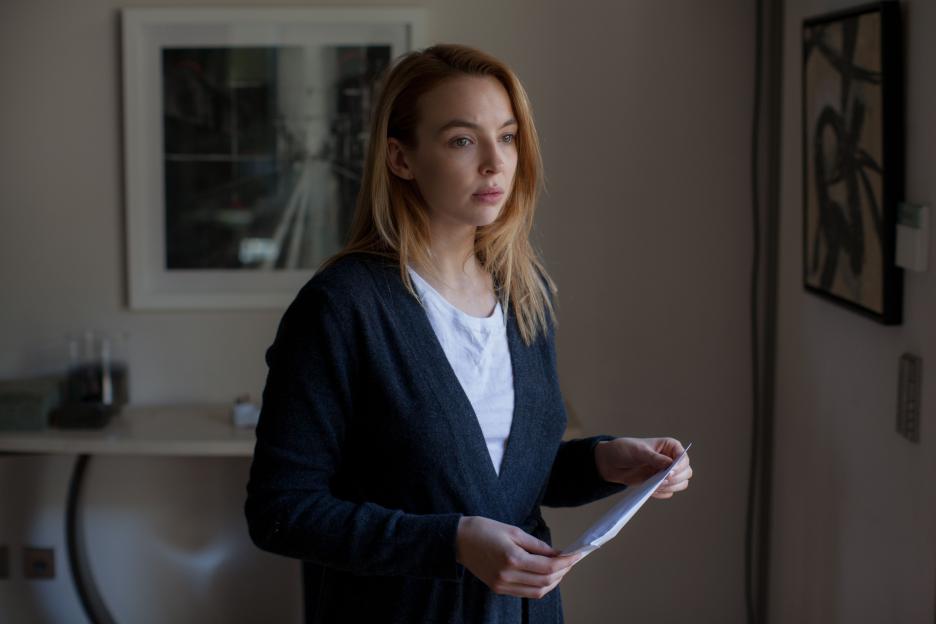 Kate Parks (Jodie Comer) looking intently while holding papers.