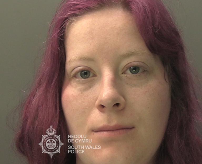 Mugshot of Shawna Miller, a woman with auburn hair and a neutral expression, looking directly at the camera.