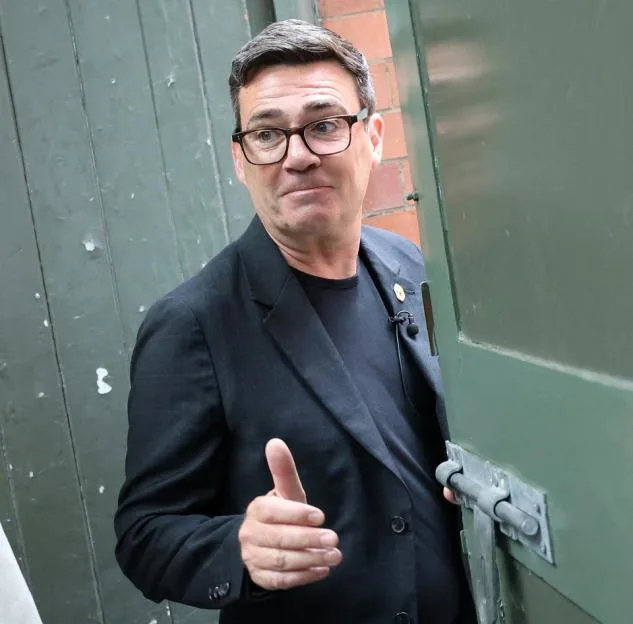 Labour MP Andy Burnham gives a thumbs-up gesture while leaving with Liverpool City Region Mayor Steve Rotheram.