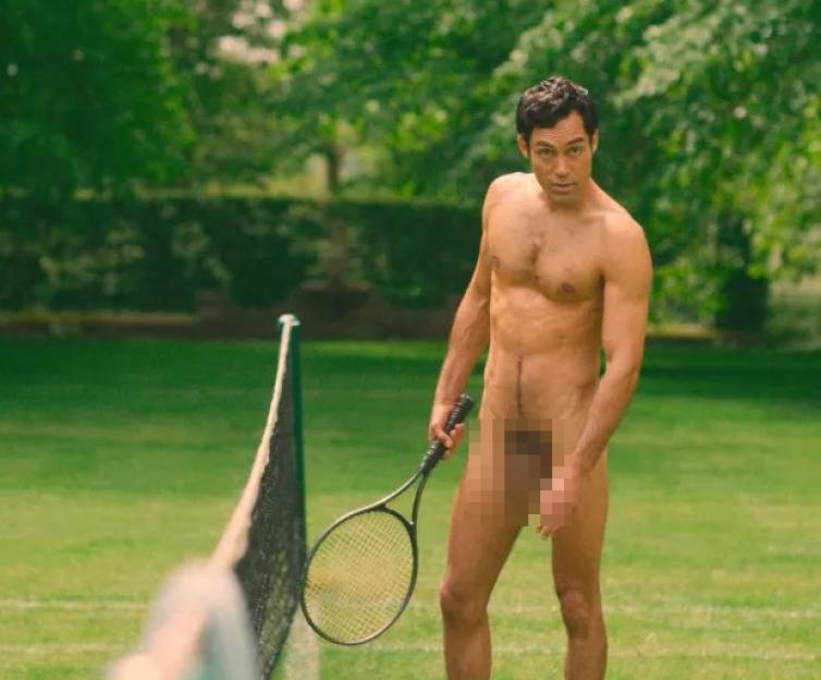 Alex Hassell's character Rupert Campbell Black standing naked on a tennis court holding a tennis racket.