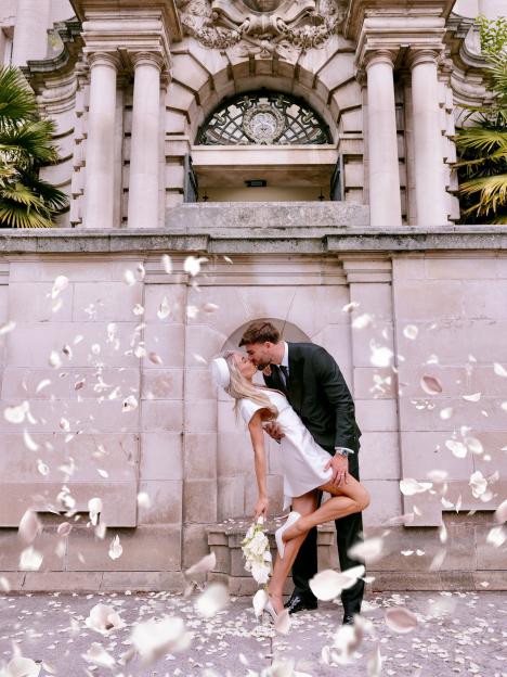 Love Island's Tom Clare and Molly Smith kissing as rose petals fall around them.