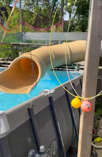 Brit dad builds own 'mini waterpark' by installing huge WATERSLIDE from garage to garden