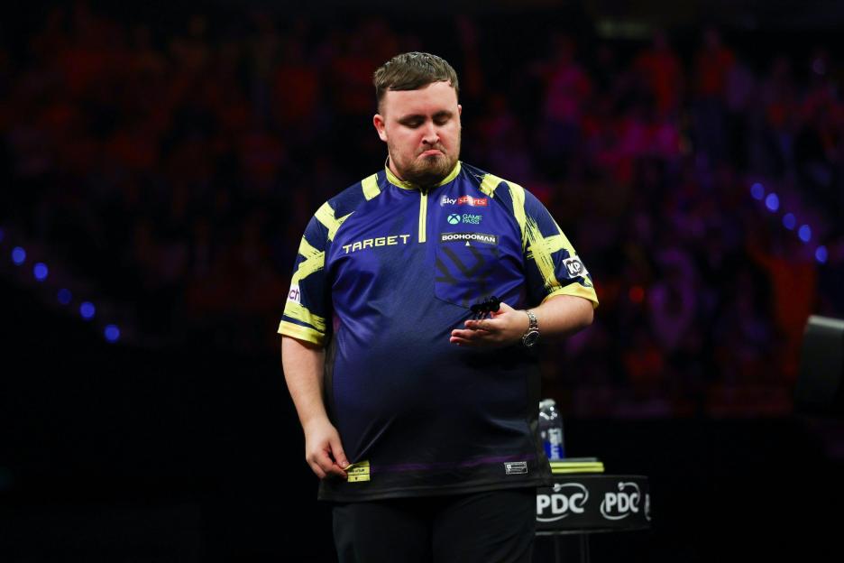 Luke Littler looking dejected with darts in hand during Premier League Darts Night 11.
