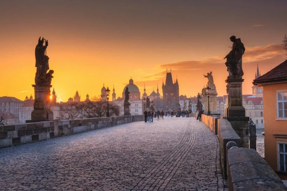 Charles Bridge in Prague, Czech Republic, during a golden sunrise.