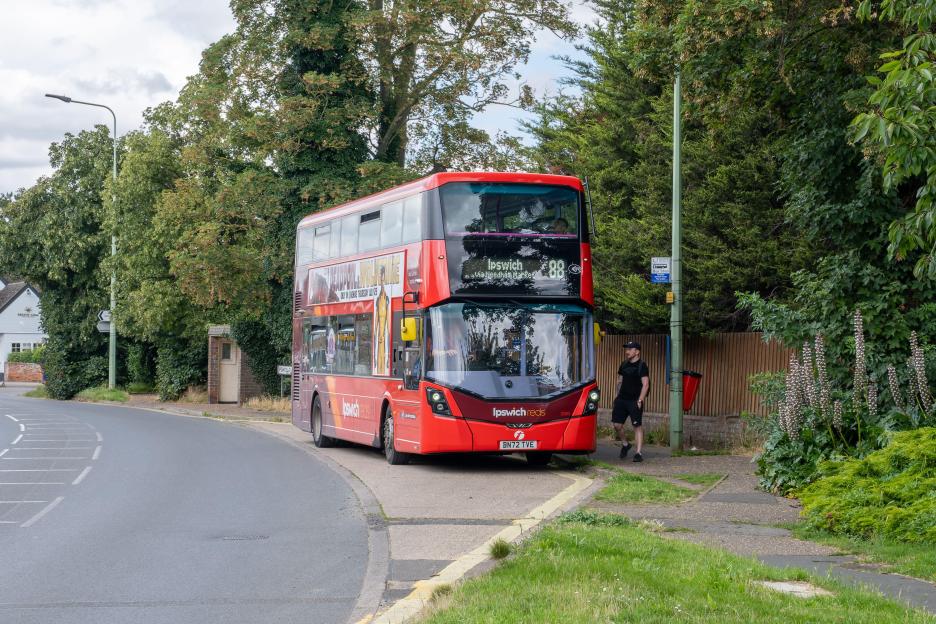 First Bus Ipswich Reds route 88 picking up passengers at the Crown bus stop in Claydon, Suffolk, UK.