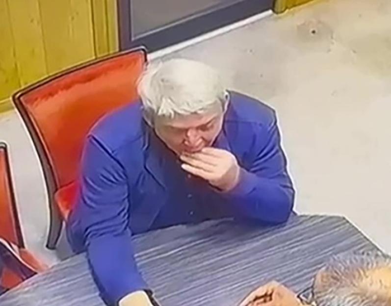 CCTV footage of a man in a jewelry store attempting to swallow an engagement ring.