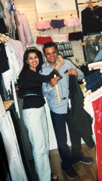 Jinda Mann and her husband, Bindu, pose together in a clothing shop.
