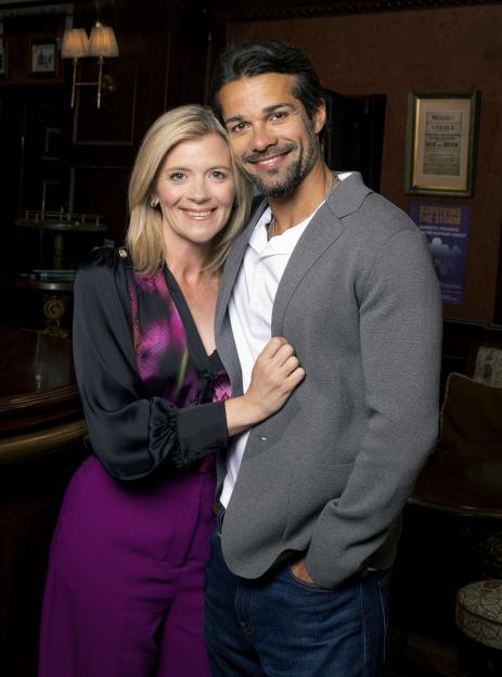 Idris Nazir and Leanne Battersby smiling together in the Rovers pub.