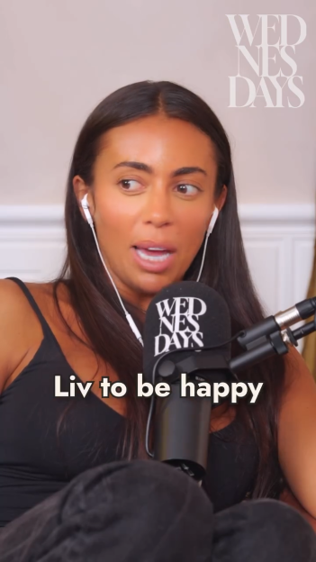 A woman with dark hair and white earbuds looks to the right, sitting in front of a microphone that says "WEDNESDAYS" and text that reads "Liv to be happy."