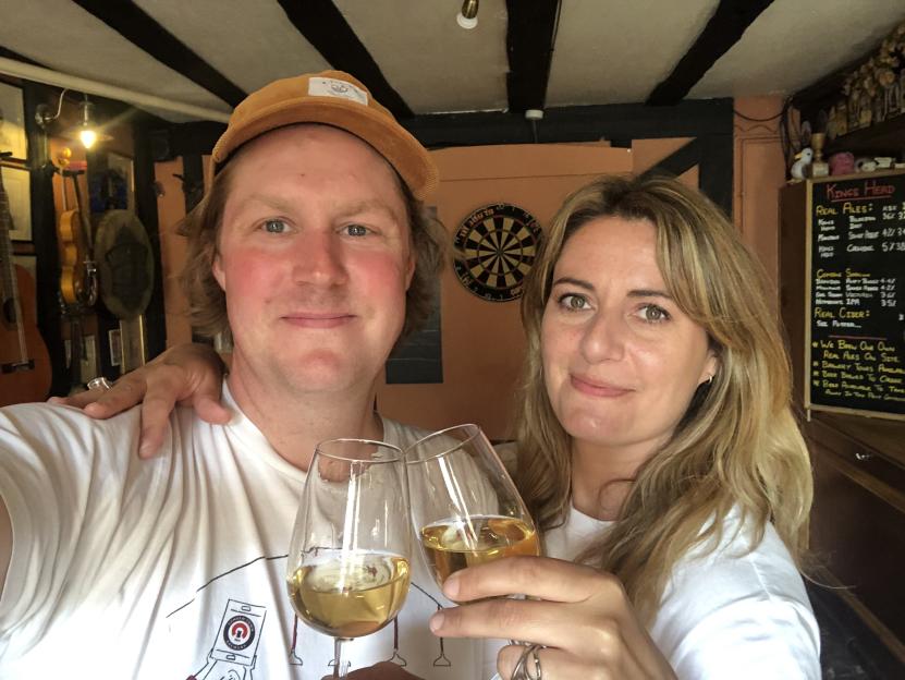 A man and a woman in a pub holding wine glasses, Pete Goss and Sophie McCreddie of Kings Head pub.
