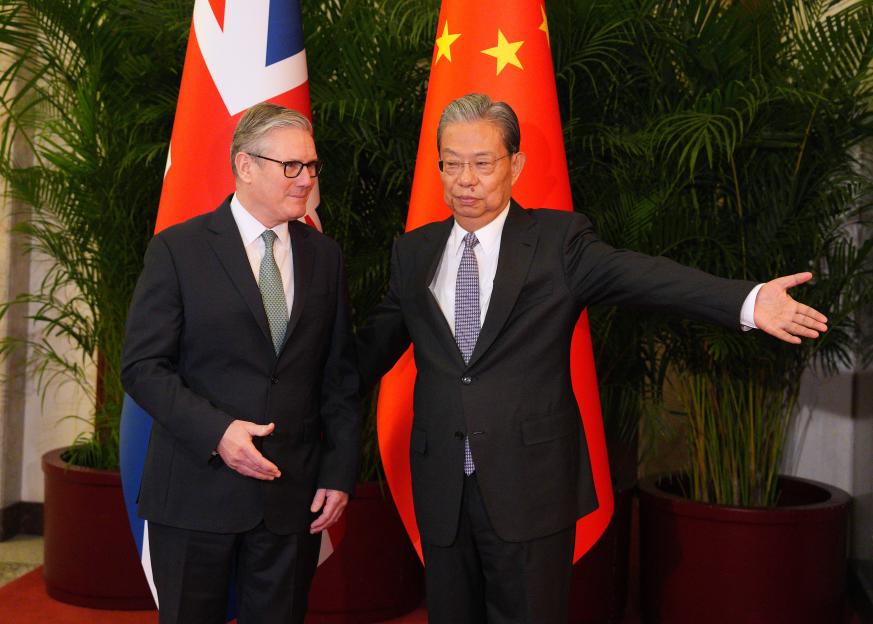 Prime Minister Sir Keir Starmer and National People's Congress Chairman Zhao Leji standing between the British and Chinese flags.