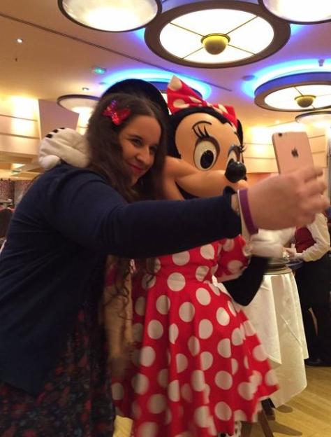 Megan Bhari taking a selfie with Minnie Mouse.