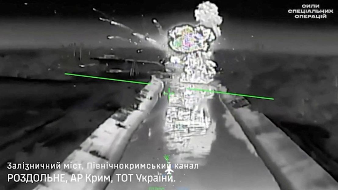 A drone footage shows fire and smoke rising from a bridge, which Ukraine's military says was destroyed by them, near Rozdolne