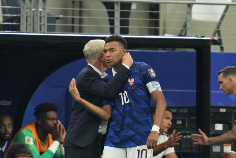 Didier Deschamps embracing Kylian Mbappé on the sidelines during the France vs Spain Semi Final.