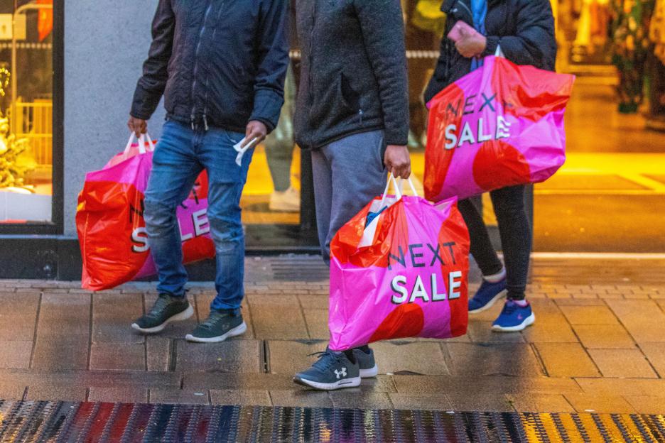 Preston, Lancashire. 27 Dec 2022. UK Weather. Damp start to the day for high street sales in Fishergate Preston. Members of the public have complained about early morning high street shoppers who are buying whole rails of clothes from Next fashion