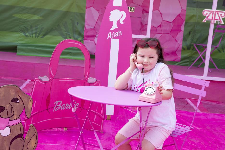 Five year-old Ayda enjoys her Barbie Dreamhouse. / A mum has spent £5,000 transforming her home into a 'Barbie Dreamhouse' - complete with pink slide. Nicole Watt, 27, has decorated the outside of...