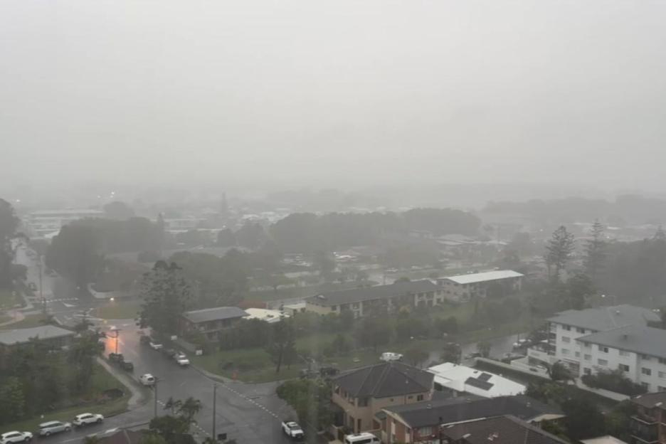 An image collage containing 1 images, Image 1 shows Aerial view of a city submerged in heavy rain