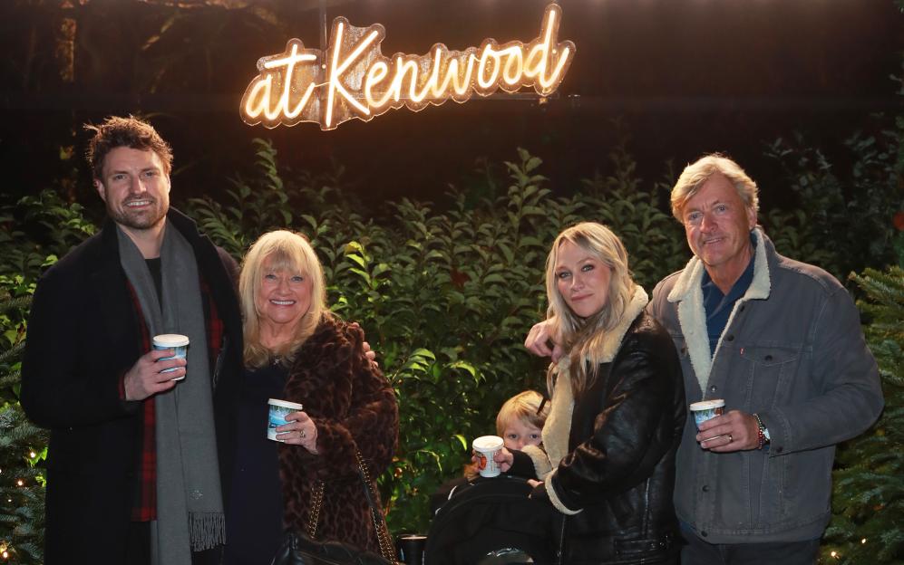 A man, two women, a child, and another man stand smiling at the Christmas At Kenwood VIP Launch.