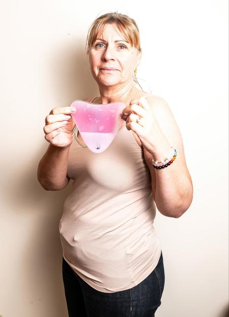 Kiara Roberts holding a pink heart-shaped patch test for her chest.