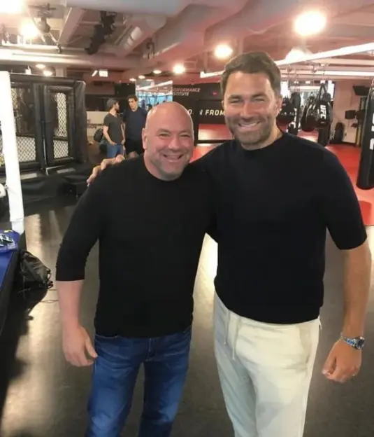 Dana White and Eddie Hearn posing together in a gym.