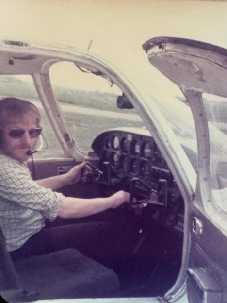 George Walker in the cockpit of a small aircraft.