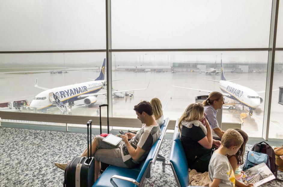 Passengers waiting at the departure gate in Stansted Airport for their Ryanair flight.