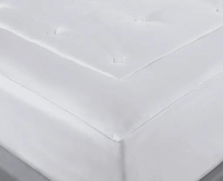 A white Lyocell mattress topper for a king-sized bed.