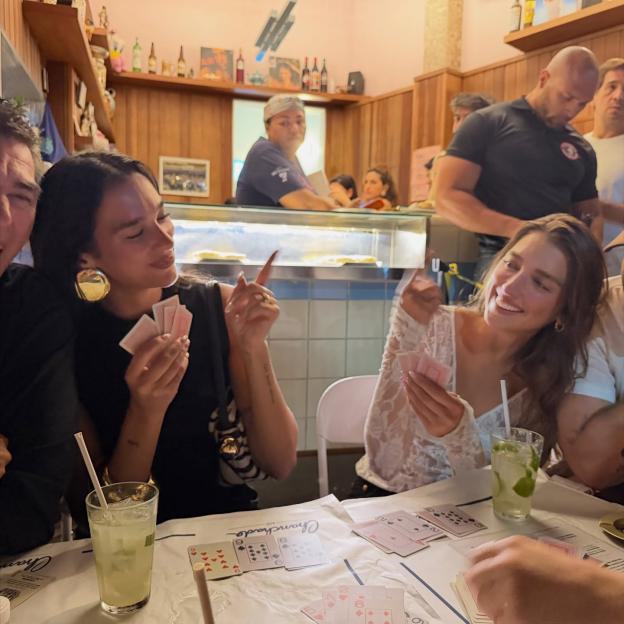 Dua Lipa playing cards with friends in Brazil.