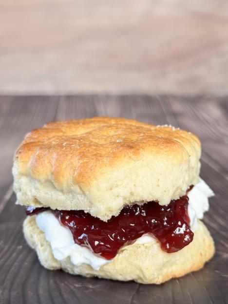 Image of classic english afternoon tea / golden scones with cornish clotted cream and strawberry jam, sweet, creamy, and jelly
