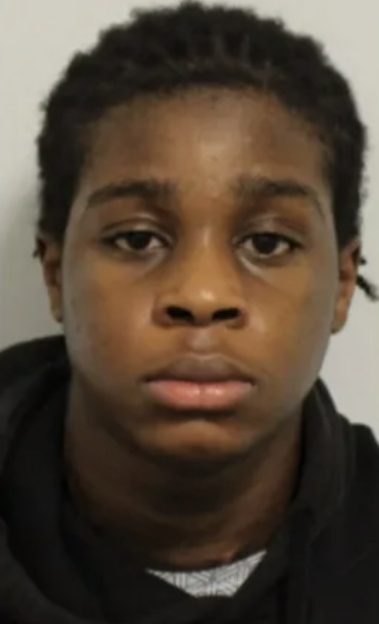 Mugshot of a young dark-skinned person looking directly at the camera.