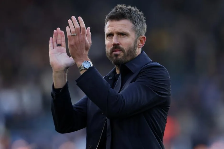 Manchester United manager Michael Carrick applauds fans from the pitch.