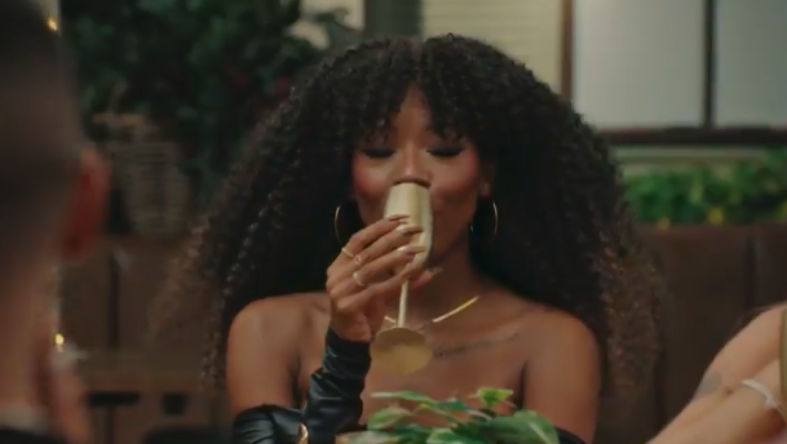 Julia-Ruth drinking from a champagne flute.