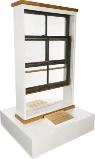 The sixth-floor window from the former Texas School Book Depository, associated with the assassination of John F. Kennedy, displayed on a stand.