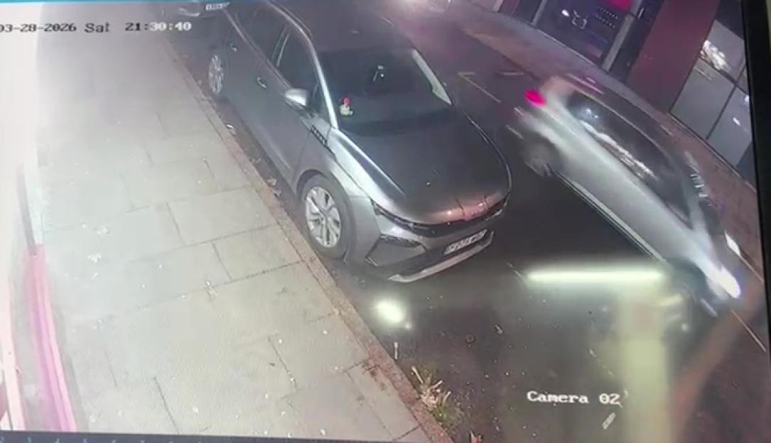 CCTV footage of a car on a road appearing to be hit by another car in a hit-and-run incident.