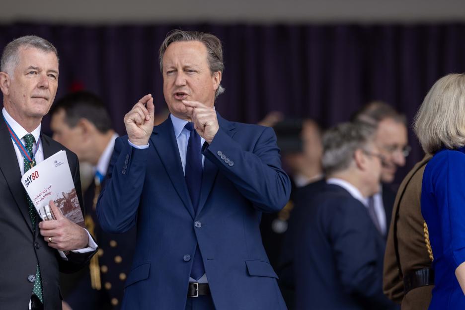 David Cameron gesturing while attending the 80th anniversary of D-Day Landings.