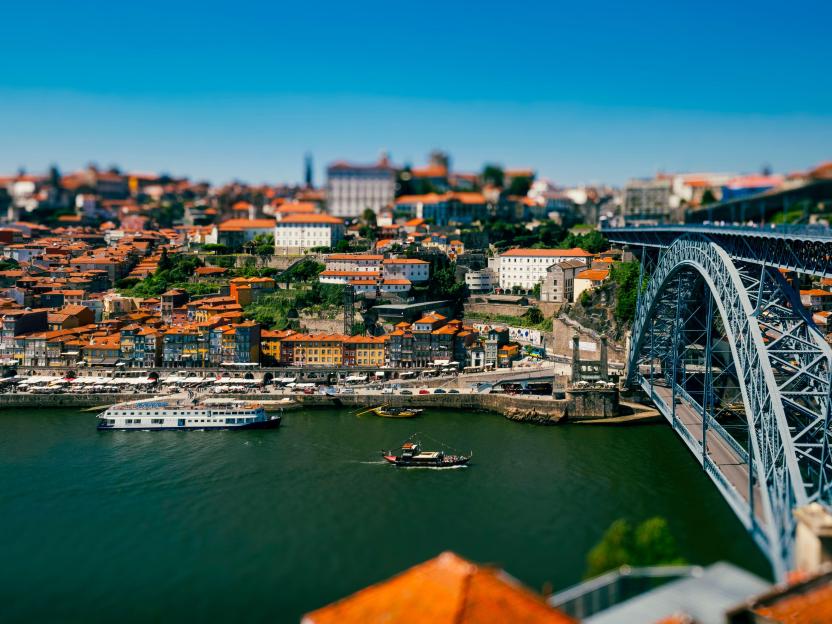 River Douro with a large, arched bridge connecting the historic city of Porto and Vila Nova de Gaia.