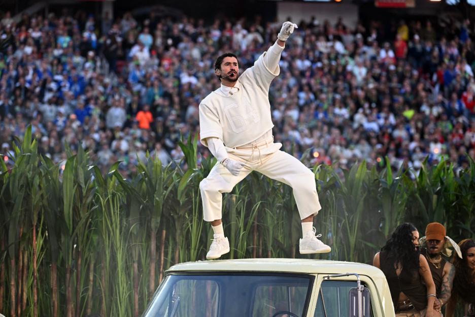 Bad Bunny performing on top of a car during the Super Bowl LX halftime show.
