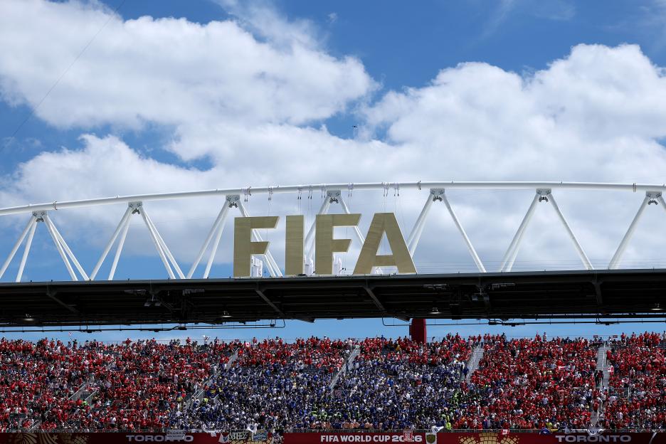 Fans in a stadium watching a FIFA World Cup 2026 match.