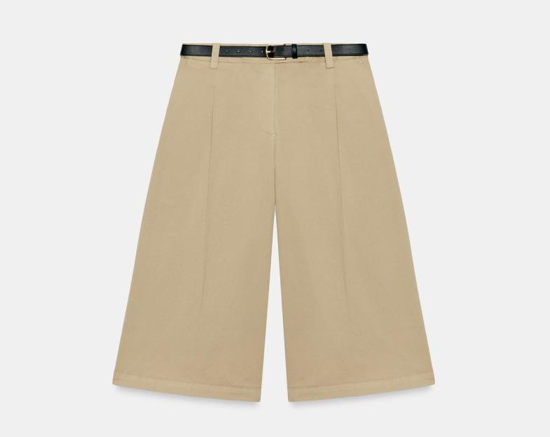 Wide-leg beige cropped pants with a black belt.