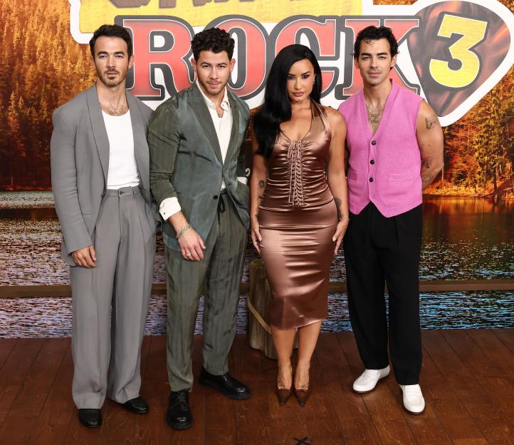 Demi Lovato, Kevin Jonas, Nick Jonas, and Joe Jonas pose at the Camp Rock 3 premiere.