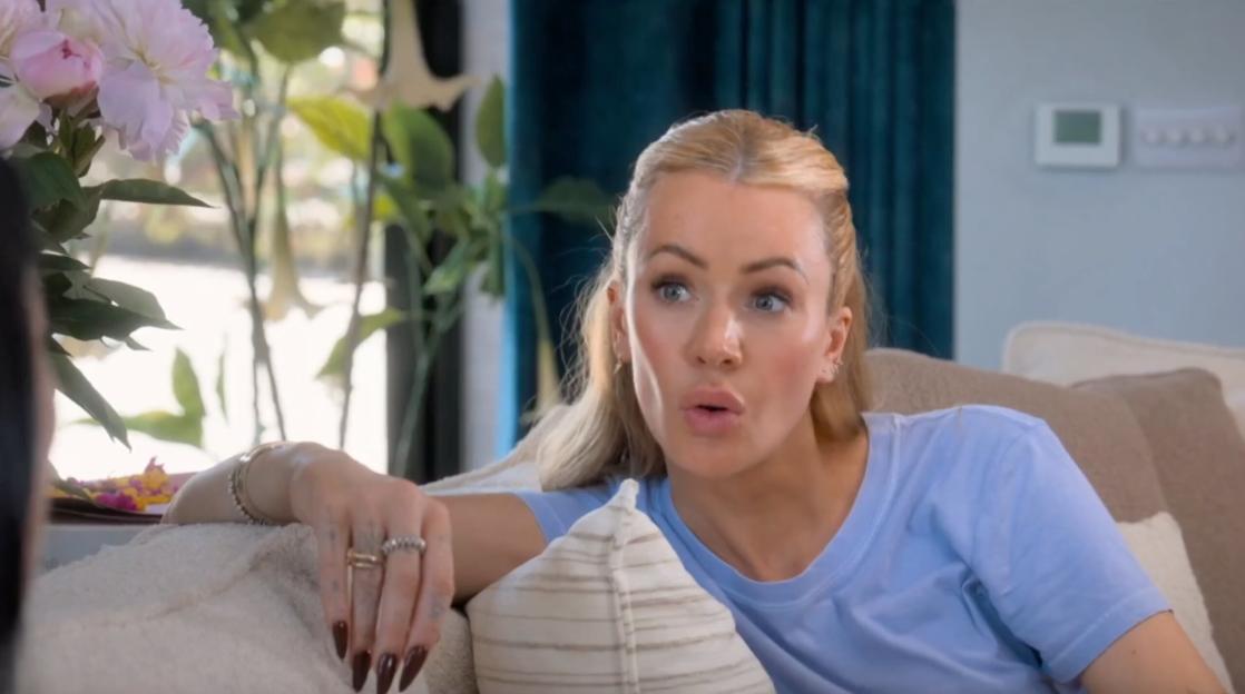 Olivia Attwood on a couch with her mouth open in a surprised expression.