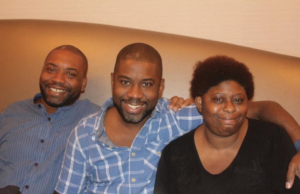 Clint, Michael, and Cheryl Collins smiling together.