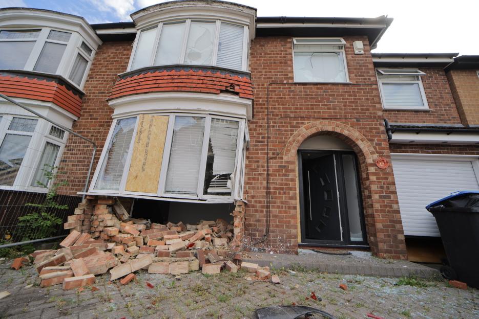 The house at 42 Ruskin Avenue in Acklam, Middlesbrough, shows a bay window on the ground floor with its brick foundation destroyed and a window boarded up.