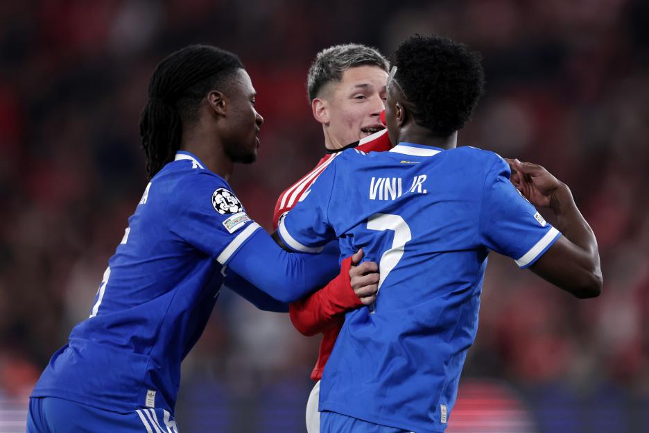 Eduardo Camavinga and Vinicius Junior of Real Madrid in a clash with Gianluca Prestianni of Benfica.